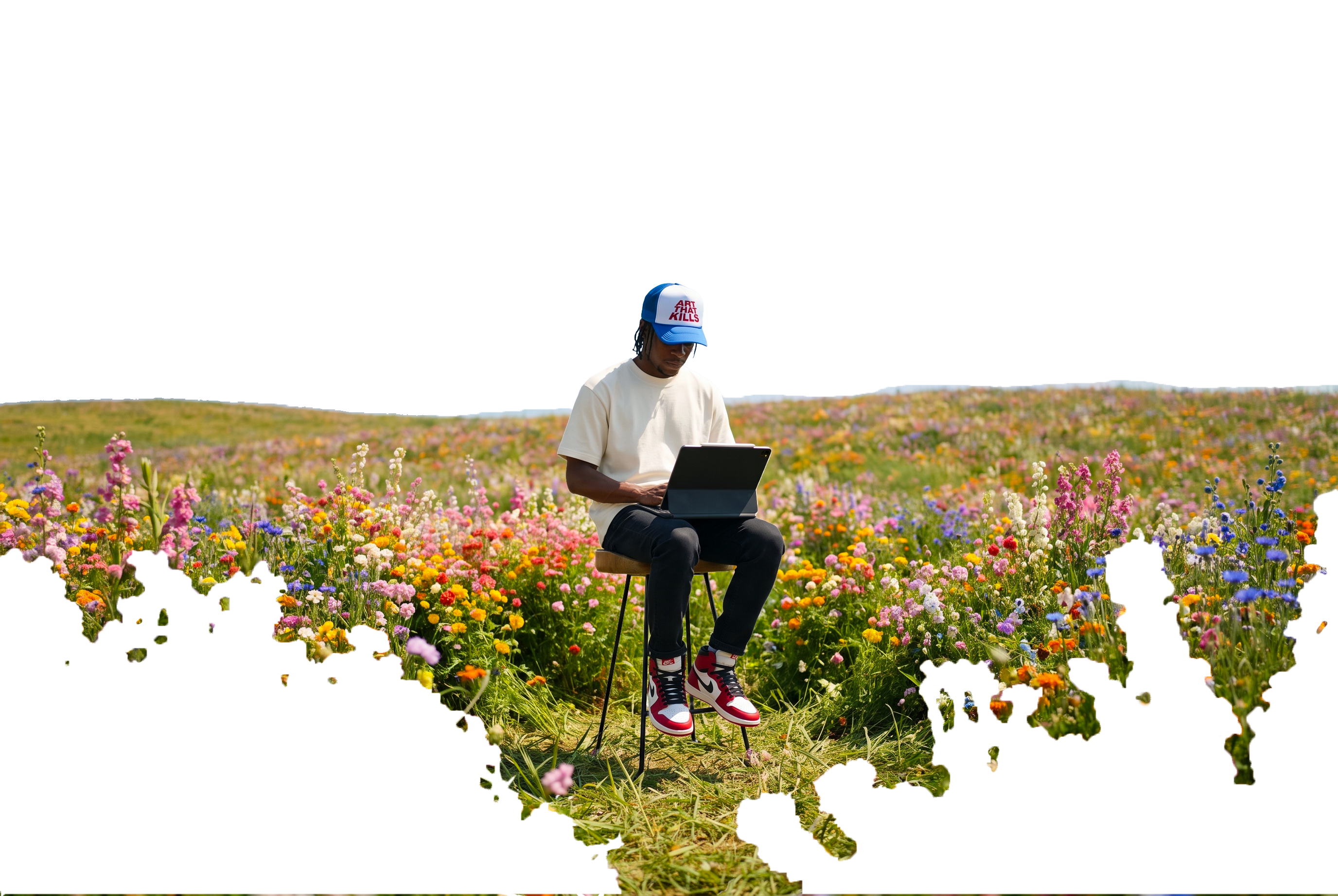 CB Mvula working on an iPad in a wildflower field
